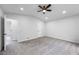 An empty bedroom with freshly painted gray walls, gray carpet, and recessed lights and two doors at 2246 Hightrail Ct, Lithonia, GA 30058