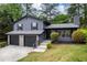 Charming two-story home with a two-car garage, landscaped front yard, and chimney at 2246 Hightrail Ct, Lithonia, GA 30058