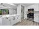 Modern kitchen features white cabinets, stainless steel appliances, and an island with quartz countertops at 2246 Hightrail Ct, Lithonia, GA 30058