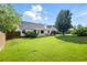 Expansive fenced backyard featuring a covered patio, lush lawn and mature trees at 2487 Battery Pointe, Lawrenceville, GA 30043