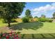 Large grassy backyard with a wooden fence and mature trees and landscaping at 2487 Battery Pointe, Lawrenceville, GA 30043
