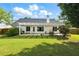 Spacious fenced backyard with a covered patio, a lawn, and lush greenery at 2487 Battery Pointe, Lawrenceville, GA 30043