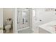 Bright bathroom featuring a shower with sliding doors, soaking tub and a vanity at 2487 Battery Pointe, Lawrenceville, GA 30043