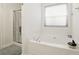 Relaxing bathroom featuring a soaking tub, a shower with sliding door, and neutral tones at 2487 Battery Pointe, Lawrenceville, GA 30043