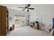 Bright bedroom with a ceiling fan, large window, and neutral tones at 2487 Battery Pointe, Lawrenceville, GA 30043