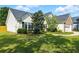 Beautifully landscaped front yard with mature trees and well-maintained lawn at 2487 Battery Pointe, Lawrenceville, GA 30043