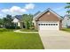 Charming one-story home with a manicured lawn, brick accents, and a two-car garage provides curb appeal at 2487 Battery Pointe, Lawrenceville, GA 30043