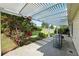 Covered patio with wrought iron furniture and landscaped fenced backyard at 2487 Battery Pointe, Lawrenceville, GA 30043