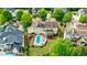 Aerial view showcases the pool, patio and outdoor area of this home among mature trees in established neighborhood at 510 Belada Blvd, Atlanta, GA 30342