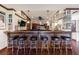 Finished basement bar with leather stools, wooden counter, and wall decor at 510 Belada Blvd, Atlanta, GA 30342