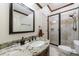 Bathroom with granite countertops, dark fixtures, and glass-enclosed shower at 510 Belada Blvd, Atlanta, GA 30342