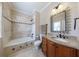 Elegant bathroom features a tub/shower combo, granite countertop, and decorative mirror at 510 Belada Blvd, Atlanta, GA 30342