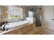 Luxury bathroom featuring a soaking tub, separate shower, decorative window, and elegant tile work at 510 Belada Blvd, Atlanta, GA 30342