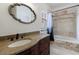 Stylish bathroom featuring a granite vanity, mosaic tile, and tub with a shower and curtain at 510 Belada Blvd, Atlanta, GA 30342