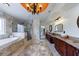 This bathroom features a soaking tub, shower, decorative window, granite counters, wood cabinets, and tile floors at 510 Belada Blvd, Atlanta, GA 30342