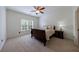 Cozy bedroom with neutral carpet, natural light, and a warm-toned ceiling fan at 510 Belada Blvd, Atlanta, GA 30342