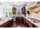 Beautiful kitchen showcases dark wood cabinets, granite countertops, and modern stainless appliances at 510 Belada Blvd, Atlanta, GA 30342