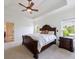 Inviting main bedroom with a decorative ceiling, king bed, ensuite bath, and bright windows at 510 Belada Blvd, Atlanta, GA 30342