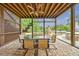 Relaxing screened patio with ceiling fan, outdoor dining, and fireplace near the pool area at 510 Belada Blvd, Atlanta, GA 30342