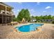 Backyard with a sparkling pool, brick patio, and outdoor fireplace at 510 Belada Blvd, Atlanta, GA 30342