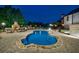 Inviting backyard pool with outdoor fireplace and seating area at night at 510 Belada Blvd, Atlanta, GA 30342