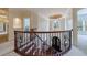 Elegant staircase with wrought iron railing, wood steps, and neutral carpeting leading to the upper level at 510 Belada Blvd, Atlanta, GA 30342