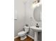 A half-bathroom featuring modern fixtures, a pedestal sink, and a wall-mounted mirror at 732 Province Se Pl, Atlanta, GA 30312