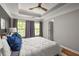 A bedroom featuring a tray ceiling, natural light, and neutral decor at 732 Province Se Pl, Atlanta, GA 30312