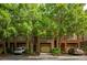 Charming townhome showcasing brick facade, private garages, and beautifully landscaped front yard with mature trees at 732 Province Se Pl, Atlanta, GA 30312
