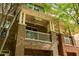 Brick townhome showcasing covered front porch with brick columns and railing and space for outdoor seating at 732 Province Se Pl, Atlanta, GA 30312