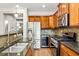 A kitchen featuring wooden cabinets, stainless steel appliances, granite countertops, and a modern faucet at 732 Province Se Pl, Atlanta, GA 30312