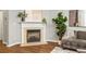 A living room featuring a fireplace with a decorative mantle, hardwood floors, and modern furnishings at 732 Province Se Pl, Atlanta, GA 30312