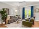 Inviting living room with a cozy couch, stylish decor, and French doors that open onto a private balcony at 732 Province Se Pl, Atlanta, GA 30312