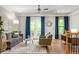 Spacious living room with a cozy couch, stylish decor, and French doors that open onto a private balcony at 732 Province Se Pl, Atlanta, GA 30312