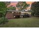 Spacious backyard featuring a deck, a well-maintained lawn, mature trees, and pleasant evening lighting at 1426 Diamond Head Dr, Decatur, GA 30033