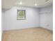 Finished basement area with carpet, window, and shelving unit at 1426 Diamond Head Dr, Decatur, GA 30033