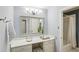 Bathroom features vanity, large mirror, drawers, and view to a separate shower/tub area at 1426 Diamond Head Dr, Decatur, GA 30033