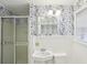 Bathroom featuring wallpaper, a vanity sink, a toilet, and a glass door shower at 1426 Diamond Head Dr, Decatur, GA 30033