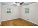 Bright bedroom with hardwood floors, ceiling fan, and natural light from the two windows at 1426 Diamond Head Dr, Decatur, GA 30033
