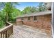 Large wooden deck overlooks the yard and is attached to the brick home at 1426 Diamond Head Dr, Decatur, GA 30033