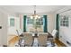 Cozy dining room with hardwood floors, modern lighting, and a view of the front yard at 1426 Diamond Head Dr, Decatur, GA 30033