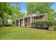 Two-story brick home featuring a manicured lawn, white columns, and a classic, timeless aesthetic at 1426 Diamond Head Dr, Decatur, GA 30033