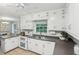 Kitchen with stainless appliances, white cabinets, tile backsplash, and bright, natural light at 1426 Diamond Head Dr, Decatur, GA 30033