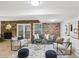 Living room featuring an exposed brick wall, ample seating, and a stylish area rug at 1426 Diamond Head Dr, Decatur, GA 30033