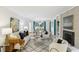 Elegant living room with hardwood floors, cozy seating, fireplace, built-in bookshelves, and dining area view at 1426 Diamond Head Dr, Decatur, GA 30033