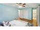 Light blue main bedroom featuring hardwood floors, stylish furniture, and ensuite bath at 1426 Diamond Head Dr, Decatur, GA 30033