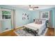 Light blue main bedroom featuring hardwood floors, stylish furniture, and large windows at 1426 Diamond Head Dr, Decatur, GA 30033
