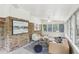Bright sunroom with brick accents, comfortable seating, and abundant natural light through large windows at 1426 Diamond Head Dr, Decatur, GA 30033
