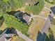 Aerial view of a beautiful home showcasing its landscaped yard and inviting curb appeal at 1520 Windsong Park Dr, Dacula, GA 30019