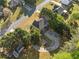Aerial view showing the home's backyard with deck, firepit, and surrounding trees at 1520 Windsong Park Dr, Dacula, GA 30019